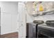 Well-equipped laundry room with modern washer and dryer, shelving and plenty of storage space at 4085 S Crystal Cir # 101, Aurora, CO 80014