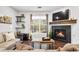 Comfortable living room with stone fireplace, large windows, and cozy sofa at 4085 S Crystal Cir # 101, Aurora, CO 80014