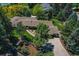 Aerial view showcases a beautiful home surrounded by lush landscaping at 4790 W Lakeridge Rd, Denver, CO 80219