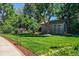 A lush backyard with a storage shed and manicured lawn at 4790 W Lakeridge Rd, Denver, CO 80219