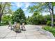 Outdoor patio features a table and chairs, surrounded by lush greenery, perfect for enjoying serene outdoor living at 4790 W Lakeridge Rd, Denver, CO 80219