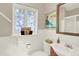 Charming bathroom showcasing decorative window and white tiling at 4790 W Lakeridge Rd, Denver, CO 80219