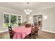 Formal dining room featuring wood floors, a classic chandelier, and a view of the landscaped yard at 4790 W Lakeridge Rd, Denver, CO 80219
