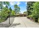 Long driveway leading up to a beautiful home with a large two car garage, surrounded by mature trees at 4790 W Lakeridge Rd, Denver, CO 80219