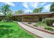 Charming home with a well-manicured lawn, stone accents, and a welcoming walkway leading to the front door at 4790 W Lakeridge Rd, Denver, CO 80219