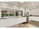 Bright kitchen features a large sink under a window and white cabinets and drawers for plenty of storage at 4790 W Lakeridge Rd, Denver, CO 80219