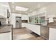 Bright kitchen features stainless steel appliances, including refrigerator, stove, dishwasher, and white cabinetry at 4790 W Lakeridge Rd, Denver, CO 80219