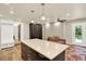 Bright kitchen featuring a spacious island, stainless steel appliances, wood flooring, and natural light at 4790 W Lakeridge Rd, Denver, CO 80219