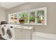 Laundry room with washer, dryer, ample storage and bright window at 4790 W Lakeridge Rd, Denver, CO 80219