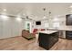 Open-concept living room with a ceiling fan and adjacent kitchen provides comfortable seating and plenty of light at 4790 W Lakeridge Rd, Denver, CO 80219