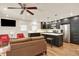 Open-concept kitchen and living room combo features a ceiling fan and stainless steel appliances at 4790 W Lakeridge Rd, Denver, CO 80219