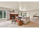 Spacious living room with a fireplace, cozy seating, and bright natural light streaming through large windows at 4790 W Lakeridge Rd, Denver, CO 80219
