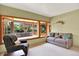 Sun-filled living room boasting a large bay window with bench seating and comfortable neutral furniture at 4790 W Lakeridge Rd, Denver, CO 80219