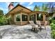 Comfortable outdoor patio featuring lounge chairs, perfect for relaxing and enjoying the serene backyard setting at 4790 W Lakeridge Rd, Denver, CO 80219