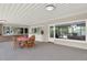 Spacious covered patio featuring a stone counter and access to the dining room, ideal for entertaining guests at 4790 W Lakeridge Rd, Denver, CO 80219