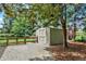 A well maintained backyard shed sits among mature trees and a wooden fence at 4790 W Lakeridge Rd, Denver, CO 80219