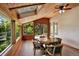 Wood-paneled sun room with a skylight and scenic views offering an inviting indoor-outdoor living space at 4790 W Lakeridge Rd, Denver, CO 80219