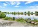 A bench sits at the edge of calm waters in this waterfront property with a clean, bright sky at 4790 W Lakeridge Rd, Denver, CO 80219