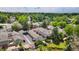 An aerial shot overlooking townhouse-style homes with mature trees, some with water views at 6929 E Briarwood Dr, Centennial, CO 80112