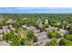 Enjoy this aerial view of the neighborhood, featuring mature trees and a community pool at 6929 E Briarwood Dr, Centennial, CO 80112