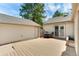 Spacious backyard deck with patio furniture, connecting the garage and home with clear skies above at 6929 E Briarwood Dr, Centennial, CO 80112