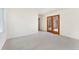 Bright bedroom with light carpet and access to the patio through sliding glass doors at 6929 E Briarwood Dr, Centennial, CO 80112