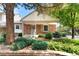 Brick home with a covered porch, neat landscaping, and mature trees creating curb appeal at 6929 E Briarwood Dr, Centennial, CO 80112