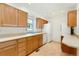 Well-lit kitchen with wood cabinets, white appliances, and tiled floor, offering a functional and stylish space at 6929 E Briarwood Dr, Centennial, CO 80112