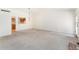 Spacious living room with an open layout, and a seamless view into the adjacent dining and kitchen areas at 6929 E Briarwood Dr, Centennial, CO 80112