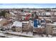 Aerial view showcasing a townhome with solar panels, winter landscape, and neighboring houses at 9875 Greensview Cir, Lone Tree, CO 80124