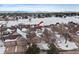 Aerial view of townhome community with snow-covered landscape and mountain views at 9875 Greensview Cir, Lone Tree, CO 80124