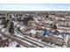 Aerial view of a townhome with solar panels in a snow-covered neighborhood at 9875 Greensview Cir, Lone Tree, CO 80124