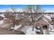 Exterior view of townhouses with snow covered driveways and landscaping at 9875 Greensview Cir, Lone Tree, CO 80124