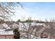 Aerial view of a snow-covered neighborhood with houses and trees at 9875 Greensview Cir, Lone Tree, CO 80124