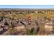 Aerial view showcases a home with brick and siding exterior and a well-manicured lawn and tree at 9875 Greensview Cir, Lone Tree, CO 80124