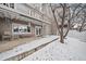 Back patio with snow-covered ground, outdoor seating, and access to the house through glass doors at 9875 Greensview Cir, Lone Tree, CO 80124