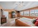 Large bedroom featuring many windows with plantation shutters and a ceiling fan at 9875 Greensview Cir, Lone Tree, CO 80124