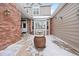 Private courtyard entrance with brick and siding at 9875 Greensview Cir, Lone Tree, CO 80124