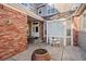 Charming courtyard with a small table set, brick accents and manicured landscape at 9875 Greensview Cir, Lone Tree, CO 80124