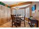 Cozy dining area featuring wood floors, a bay window, and shutter blinds at 9875 Greensview Cir, Lone Tree, CO 80124