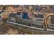 An aerial view showcasing the home's rear exterior with a fence, deck, and solar panels on the roof at 9875 Greensview Cir, Lone Tree, CO 80124