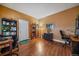 Home office with built-in bookshelves and hardwood floors at 9875 Greensview Cir, Lone Tree, CO 80124