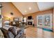 Cozy living room featuring a fireplace, hardwood floors, and ample natural light at 9875 Greensview Cir, Lone Tree, CO 80124