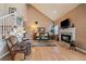 Inviting living room with fireplace, vaulted ceiling, and hardwood floors at 9875 Greensview Cir, Lone Tree, CO 80124