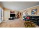 Spacious living room with carpet, a tv, and access to an upstairs hallway, perfect for relaxation at 9875 Greensview Cir, Lone Tree, CO 80124