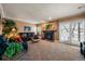 Inviting living room with fireplace, plush furniture, and natural light from the sliding glass doors at 9875 Greensview Cir, Lone Tree, CO 80124