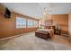 Main bedroom with vaulted ceilings, plush carpet, and large windows at 9875 Greensview Cir, Lone Tree, CO 80124