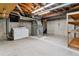 Unfinished basement with laundry hookups and shelving at 12224 E Amherst Cir, Aurora, CO 80014