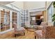 Bright sunroom with built-in shelving and view to living room at 12224 E Amherst Cir, Aurora, CO 80014