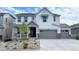 Beautiful two-story home featuring a gray two car garage and a charming covered porch at 3955 Descent St, Castle Rock, CO 80108